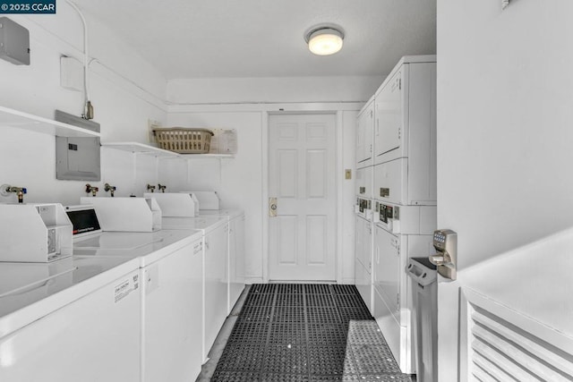 clothes washing area featuring electric panel, separate washer and dryer, and stacked washer and dryer