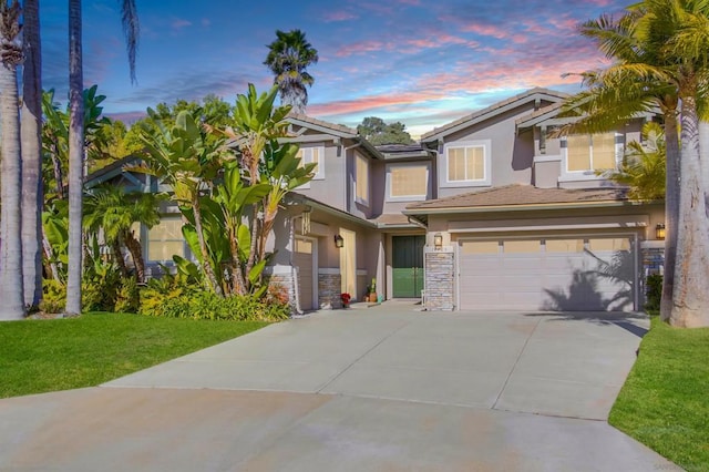 view of front of property featuring a garage and a yard