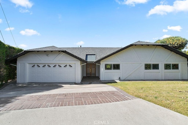 view of front facade featuring a garage, a shingled roof, decorative driveway, a front lawn, and stucco siding