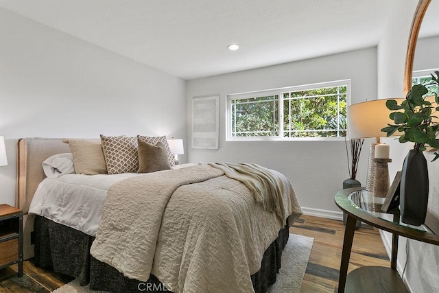 bedroom with dark hardwood / wood-style flooring