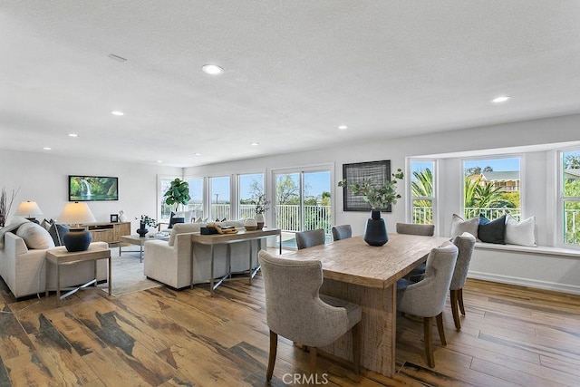 dining area with plenty of natural light, a textured ceiling, hardwood / wood-style floors, and recessed lighting