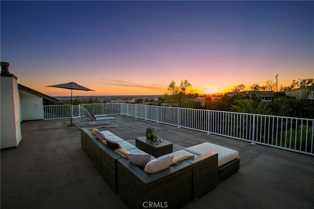 patio terrace at dusk featuring an outdoor living space