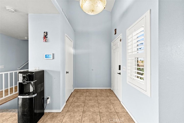 hallway featuring light tile patterned floors