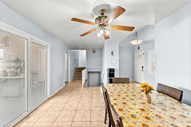 unfurnished dining area with ceiling fan and light tile patterned floors