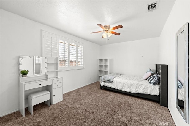 bedroom featuring ceiling fan and dark carpet