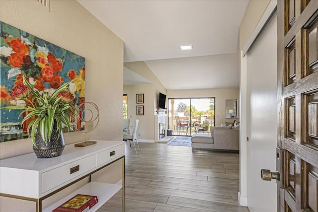 entrance foyer with hardwood / wood-style flooring and lofted ceiling