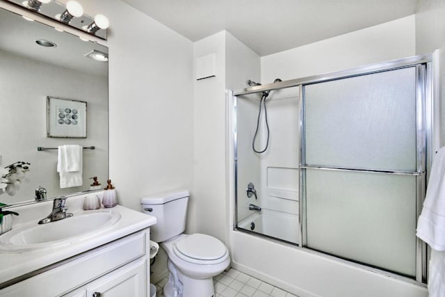 full bathroom featuring bath / shower combo with glass door, tile patterned floors, vanity, and toilet