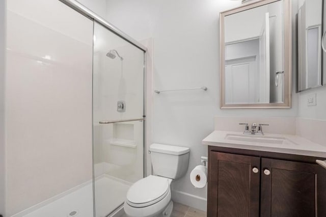 bathroom featuring vanity, walk in shower, and toilet