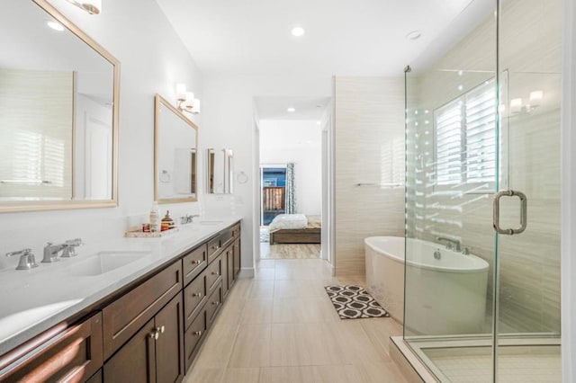 bathroom featuring vanity, tile patterned floors, shower with separate bathtub, and tile walls