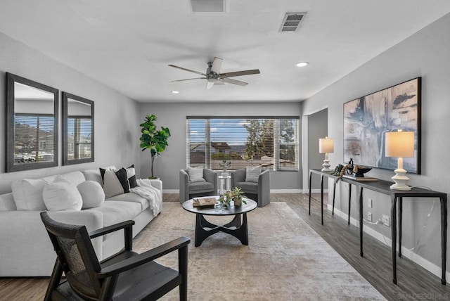 living room with hardwood / wood-style flooring and ceiling fan