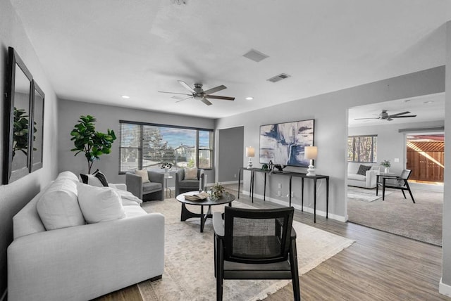 living room featuring ceiling fan and hardwood / wood-style floors