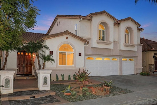 mediterranean / spanish-style home featuring a garage