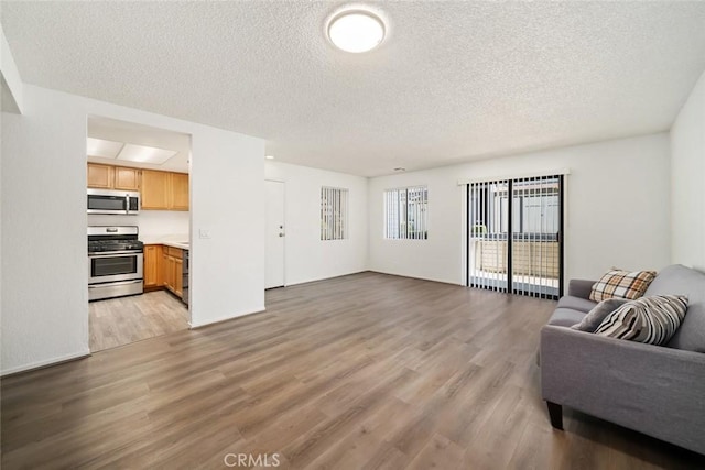 living room featuring light hardwood / wood-style floors and a textured ceiling