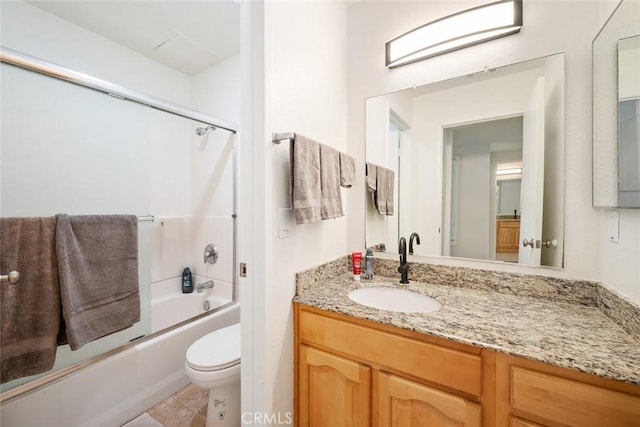 full bathroom with vanity, toilet, bath / shower combo with glass door, and tile patterned flooring