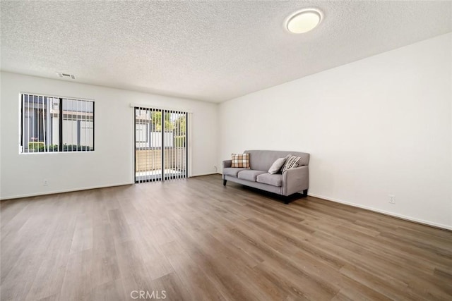 unfurnished room featuring a textured ceiling and wood-type flooring