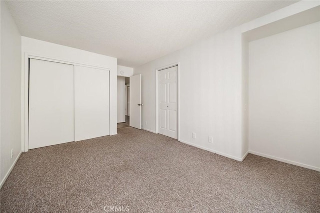 unfurnished bedroom with carpet and a textured ceiling