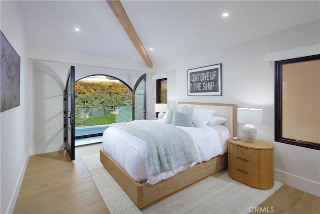 bedroom with light hardwood / wood-style floors, wooden ceiling, and lofted ceiling with beams