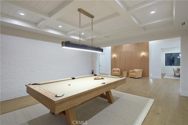 rec room with beamed ceiling, light hardwood / wood-style floors, coffered ceiling, billiards, and brick wall