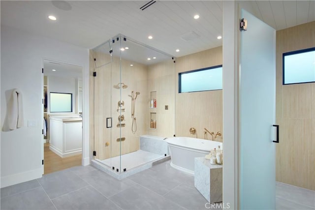 bathroom with tile patterned flooring and plus walk in shower