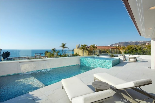 view of pool featuring pool water feature and a water view