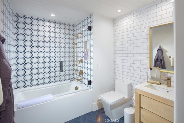 full bathroom featuring toilet, tile walls, parquet floors, vanity, and tub / shower combination