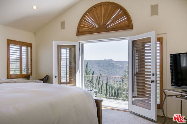 carpeted bedroom with lofted ceiling and access to exterior