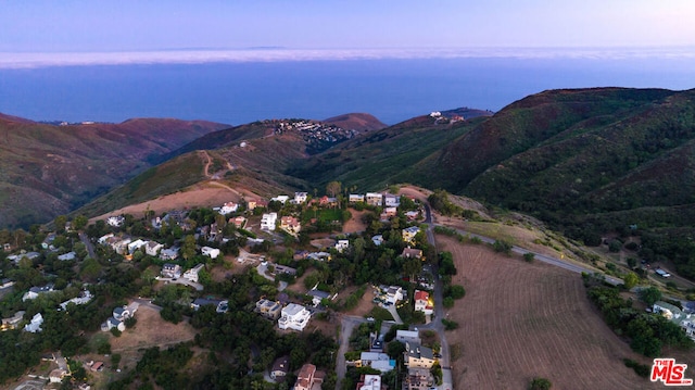 aerial view at dusk featuring a mountain view