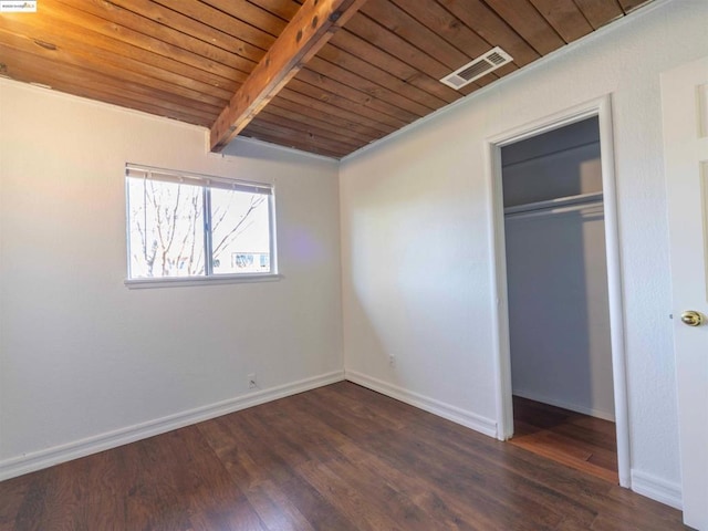 unfurnished bedroom featuring wood ceiling, beamed ceiling, dark hardwood / wood-style flooring, and a closet