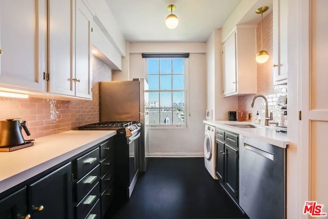 kitchen with washer / dryer, appliances with stainless steel finishes, white cabinetry, hanging light fixtures, and sink