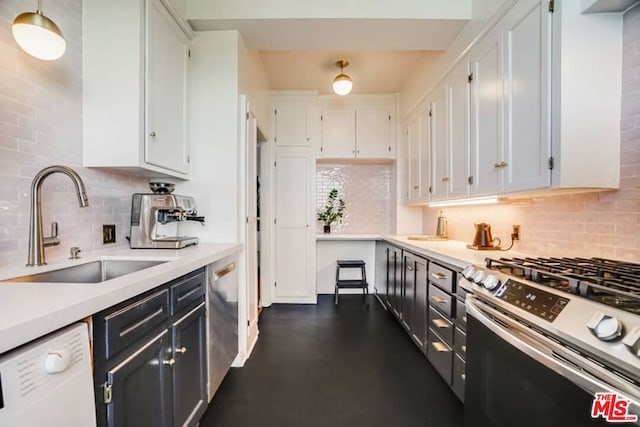 kitchen with sink, white cabinets, tasteful backsplash, and appliances with stainless steel finishes