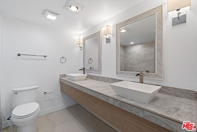 bathroom featuring vanity, toilet, and tile patterned flooring