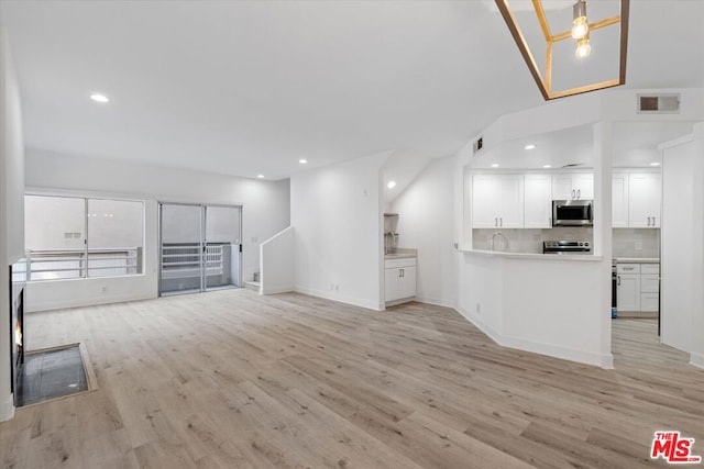 unfurnished living room with light hardwood / wood-style flooring