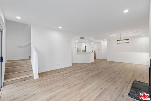 unfurnished living room with light wood-type flooring