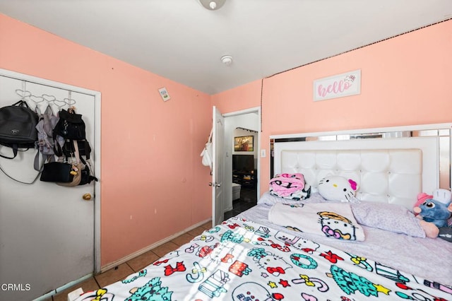 bedroom with a closet and light tile patterned floors