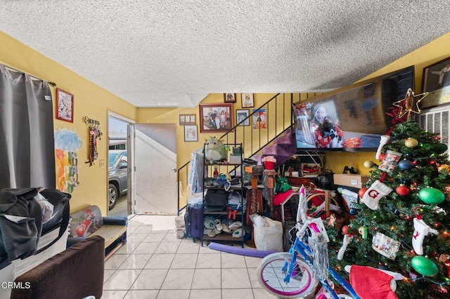 misc room with light tile patterned flooring and a textured ceiling