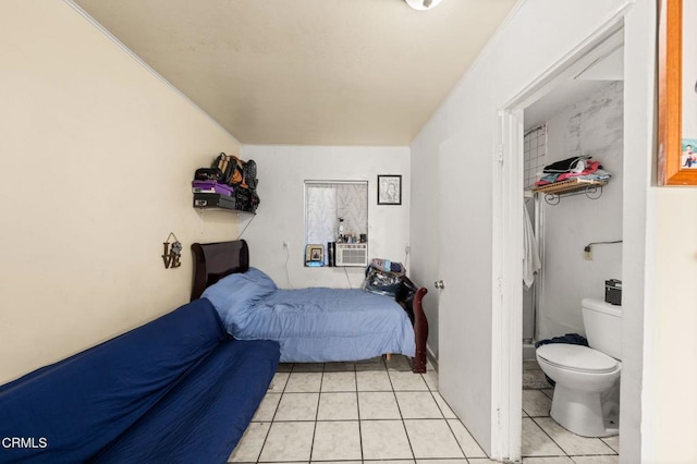 tiled bedroom featuring ensuite bathroom