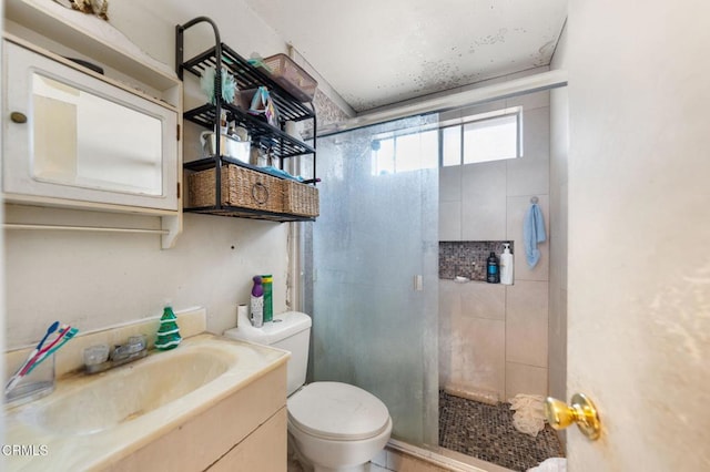 bathroom featuring toilet, an enclosed shower, and vanity