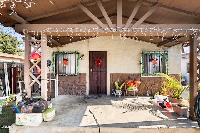 view of exterior entry featuring a patio