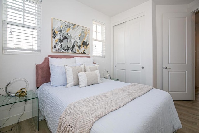 bedroom featuring hardwood / wood-style floors and a closet