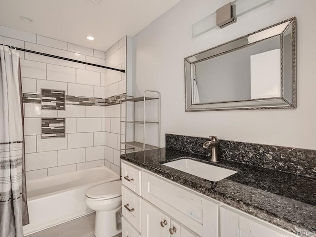 full bathroom with shower / tub combo with curtain, vanity, and toilet