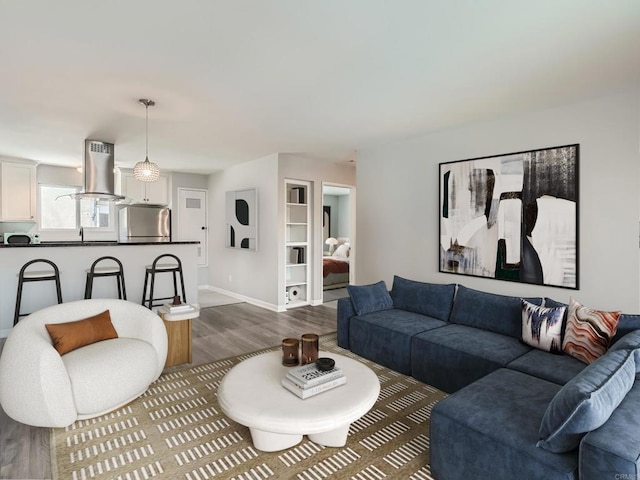 living room with baseboards and wood finished floors