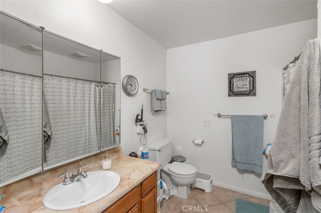 bathroom with tile patterned floors, toilet, and vanity