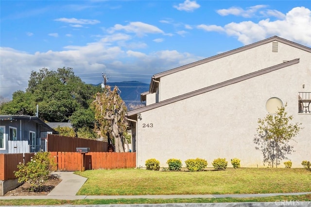 view of side of property with a lawn