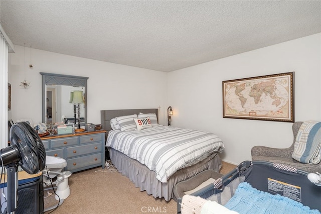 bedroom featuring light carpet and a textured ceiling