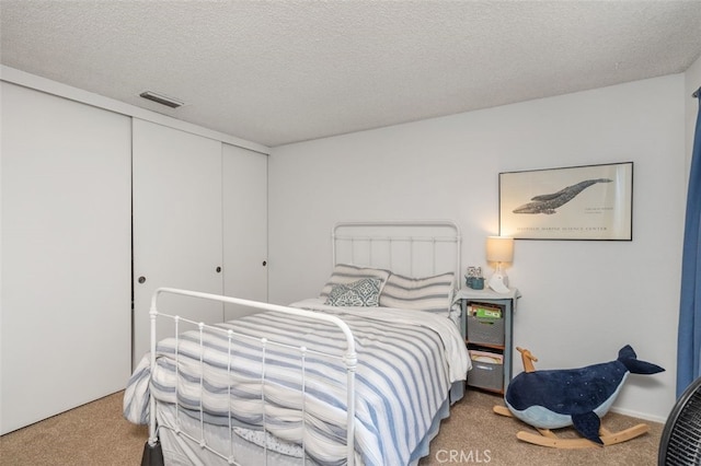 carpeted bedroom with a textured ceiling