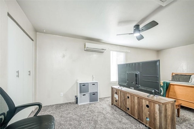 sitting room with carpet flooring, a wall mounted air conditioner, and a ceiling fan
