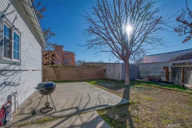 fenced backyard featuring a patio