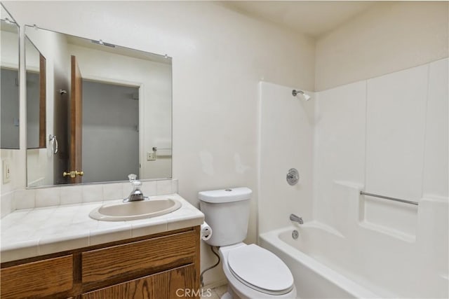 bathroom with toilet, vanity, and shower / tub combination