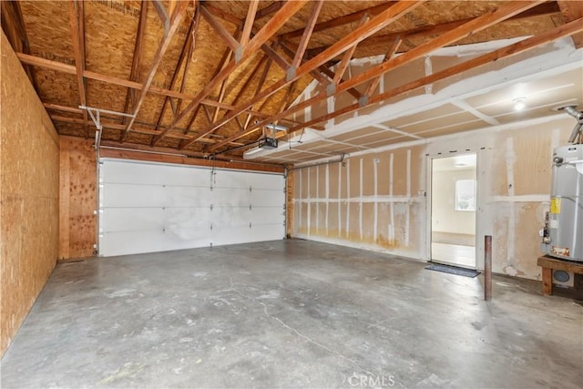 garage with gas water heater and a garage door opener