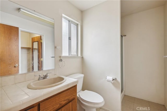 full bath with toilet, a shower with shower door, and vanity